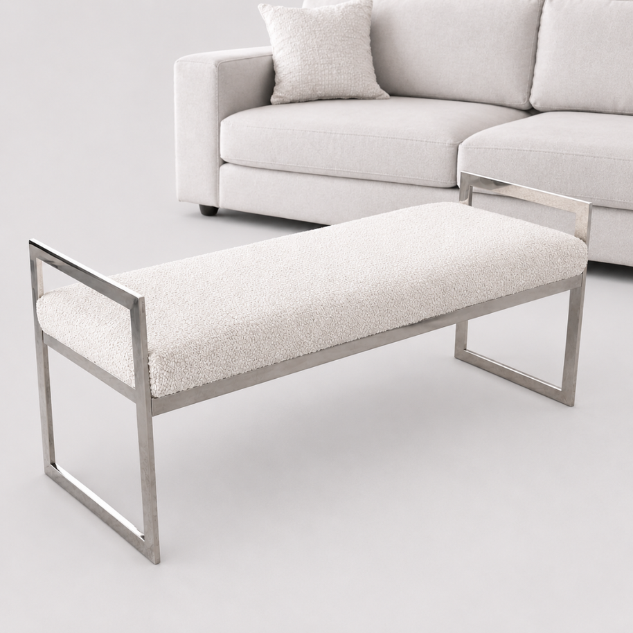 cream bench in a professional photography studio with a cream sofa in the background