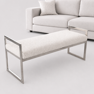 cream bench in a professional photography studio with a cream sofa in the background