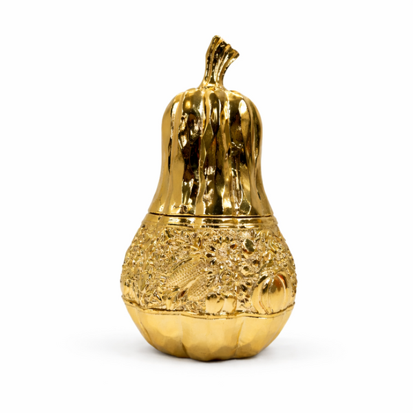 Gold decorative object shaped like a gourd on a white background