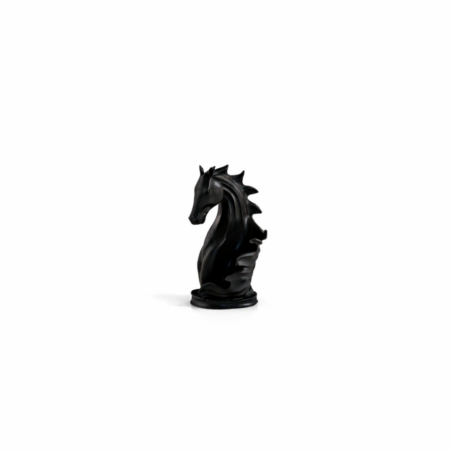 Sculptural matte black horse wine bottle holder cradling a bottle on a modern wooden bar top.