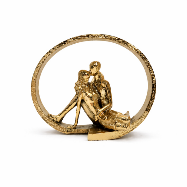 Bronze ornament of a couple embracing inside a circular frame on a white background