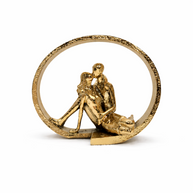 Bronze ornament of a couple embracing inside a circular frame on a white background