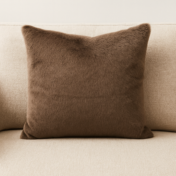 Brown furr material cushion on beige sofa