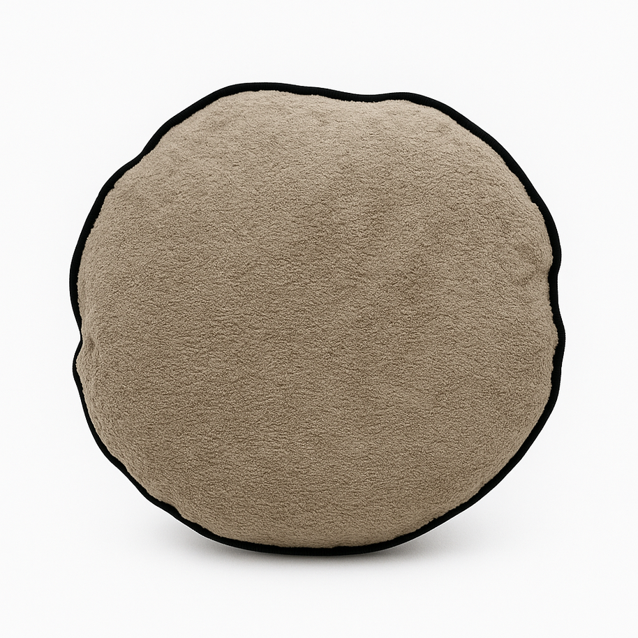 Round beige cushion with a black border on a white background
