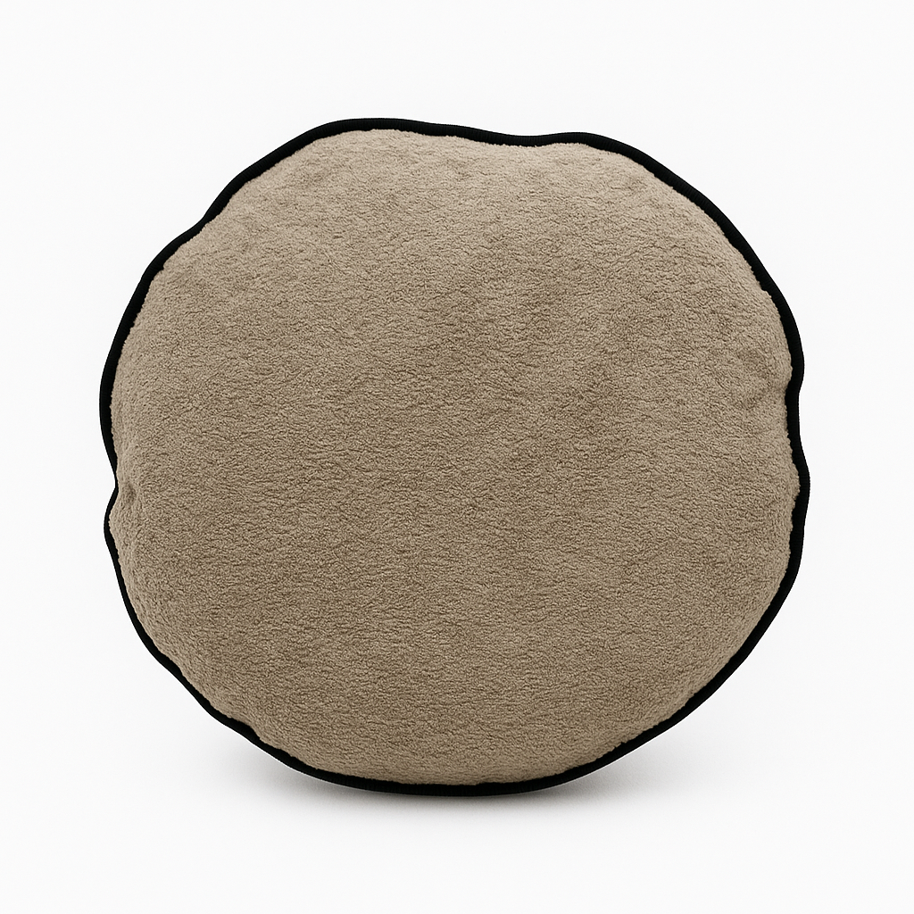 Round beige cushion with a black border on a white background
