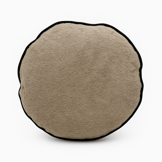 Round beige cushion with a black border on a white background