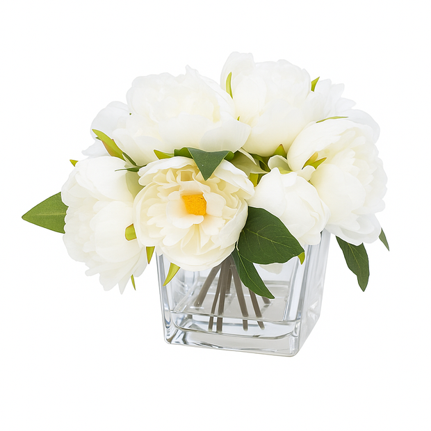 White flowers in a clear glass vase on a white background