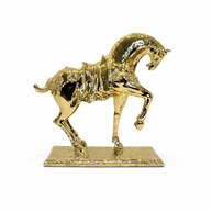 Polished gold horse statue with a raised front leg displayed on a white background.