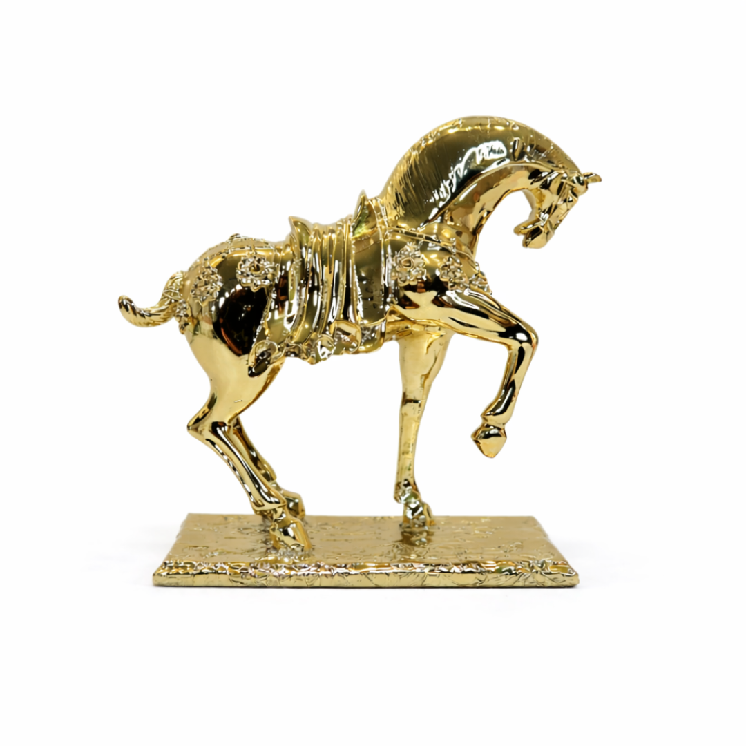 Polished gold horse statue with a raised front leg displayed on a white background.