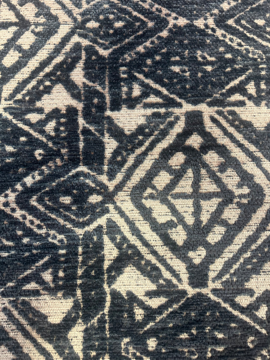 Close-up of a textured fabric with geometric pattern in navy blue and white