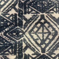 Close-up of a textured fabric with geometric pattern in navy blue and white