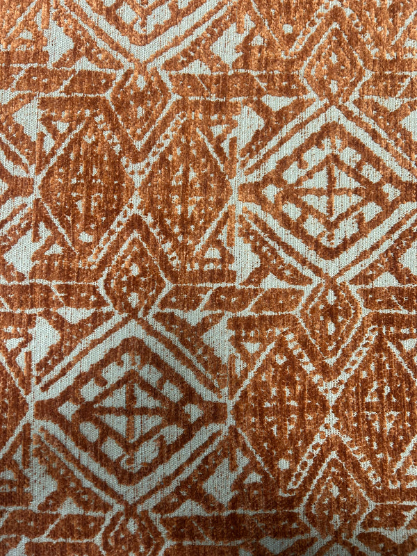 Close-up of a textured fabric with a geometric pattern in brown and beige.