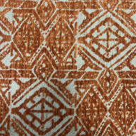Close-up of a textured fabric with a geometric pattern in brown and beige.