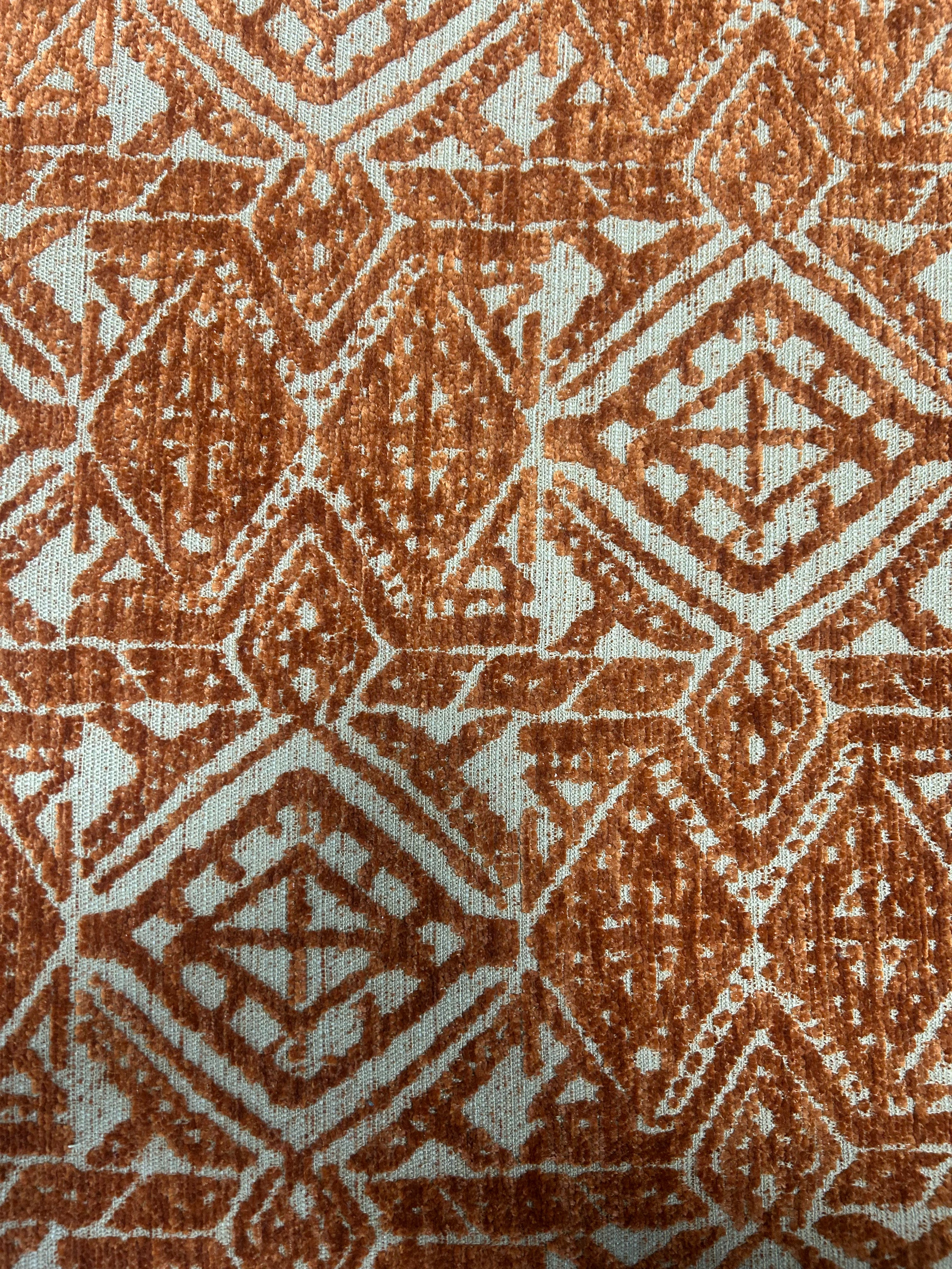 Close-up of a textured fabric with a geometric pattern in brown and beige.