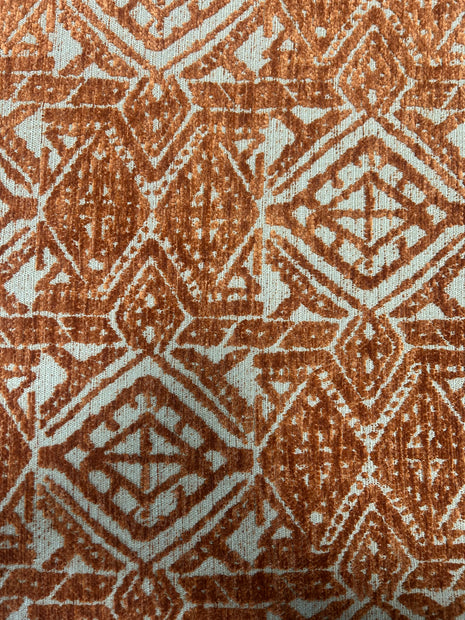 Close-up of a textured fabric with a geometric pattern in brown and beige.