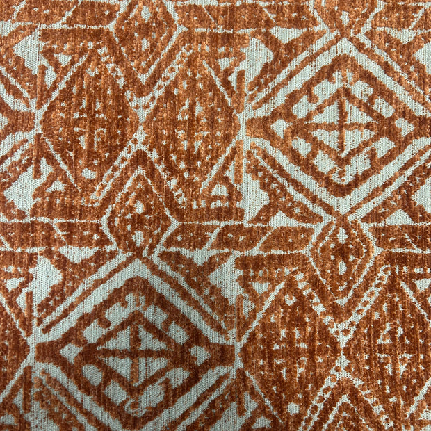 Close-up of a textured fabric with a geometric pattern in brown and beige.