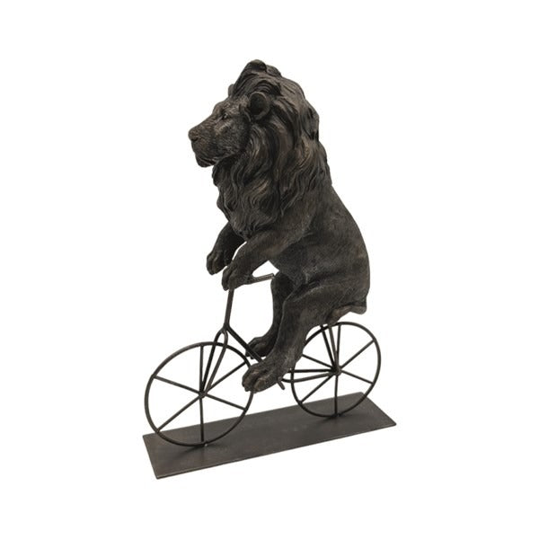 Statue of a lion riding a bicycle on a white background