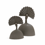 Pair of modern taupe sculptural figures with fan-shaped headdresses on a light oak console table.