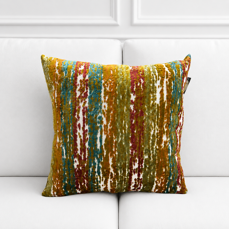 Multicolored striped pillow on a white sofa