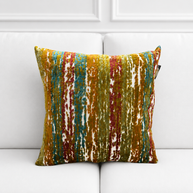 Multicolored striped pillow on a white sofa