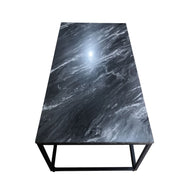 Marble-patterned table with black metal legs on a white background
