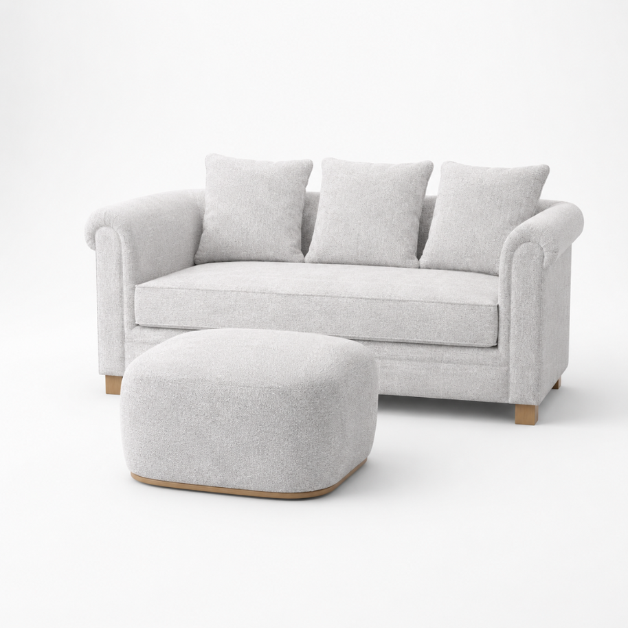 Light gray sofa with three cushions and a matching ottoman on a white background