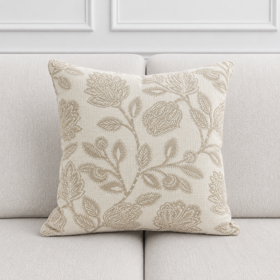 Decorative pillow with floral pattern on a light gray sofa