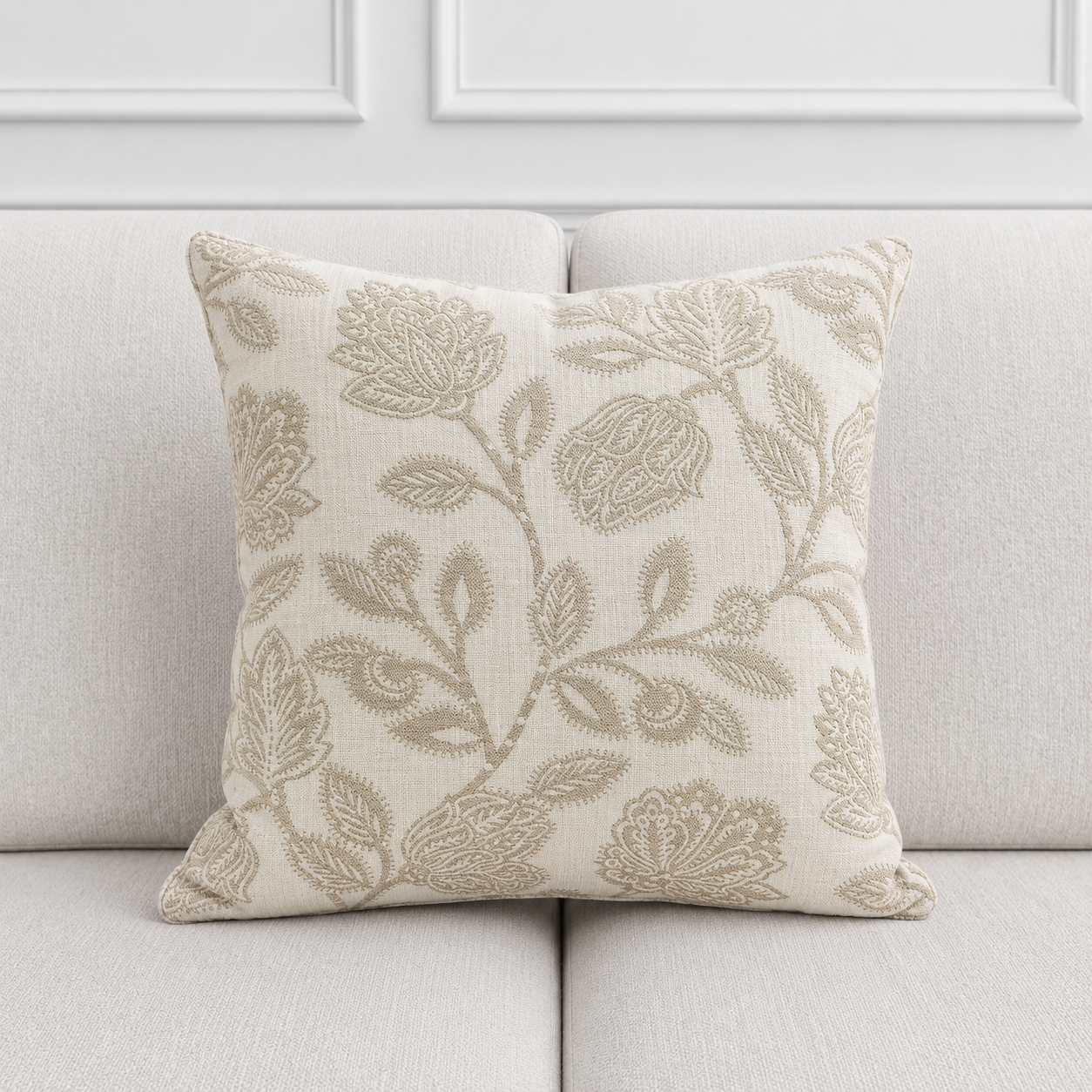 Decorative pillow with floral pattern on a light gray sofa