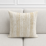 Textured pillow on a light gray sofa with a neutral color palette