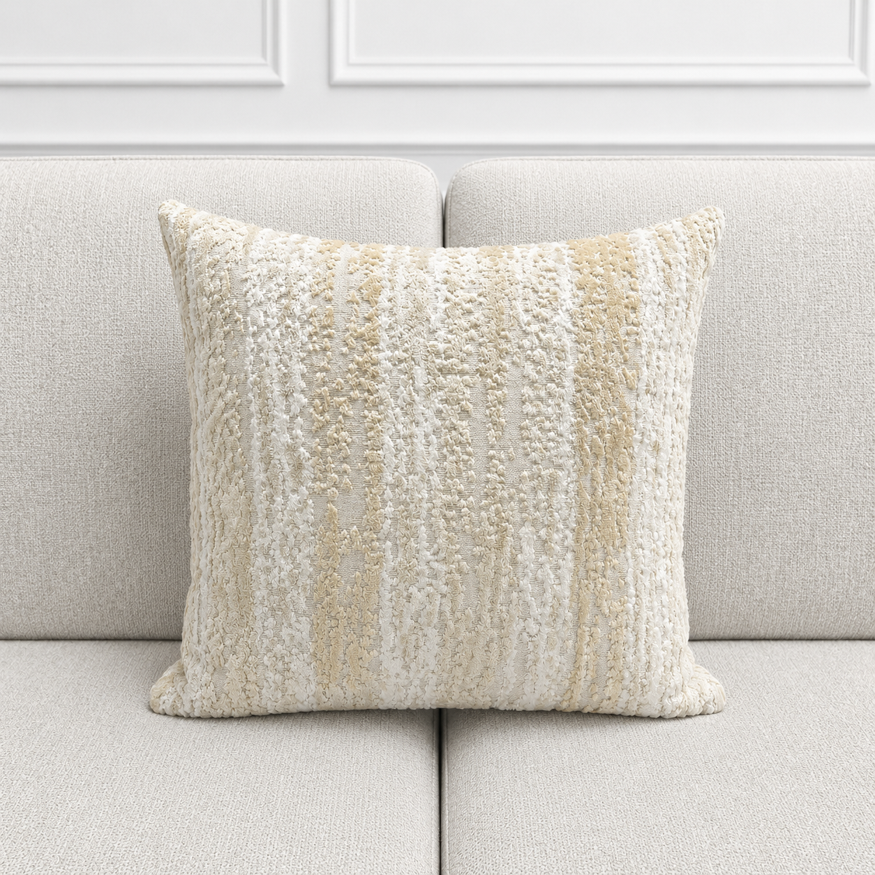 Textured pillow on a light gray sofa with a neutral color palette