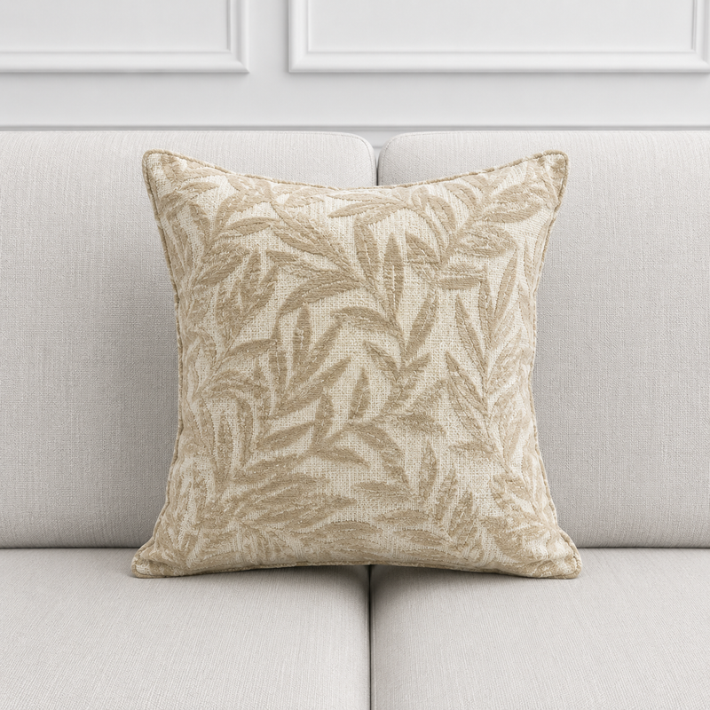 Decorative pillow with leaf pattern on a light gray sofa