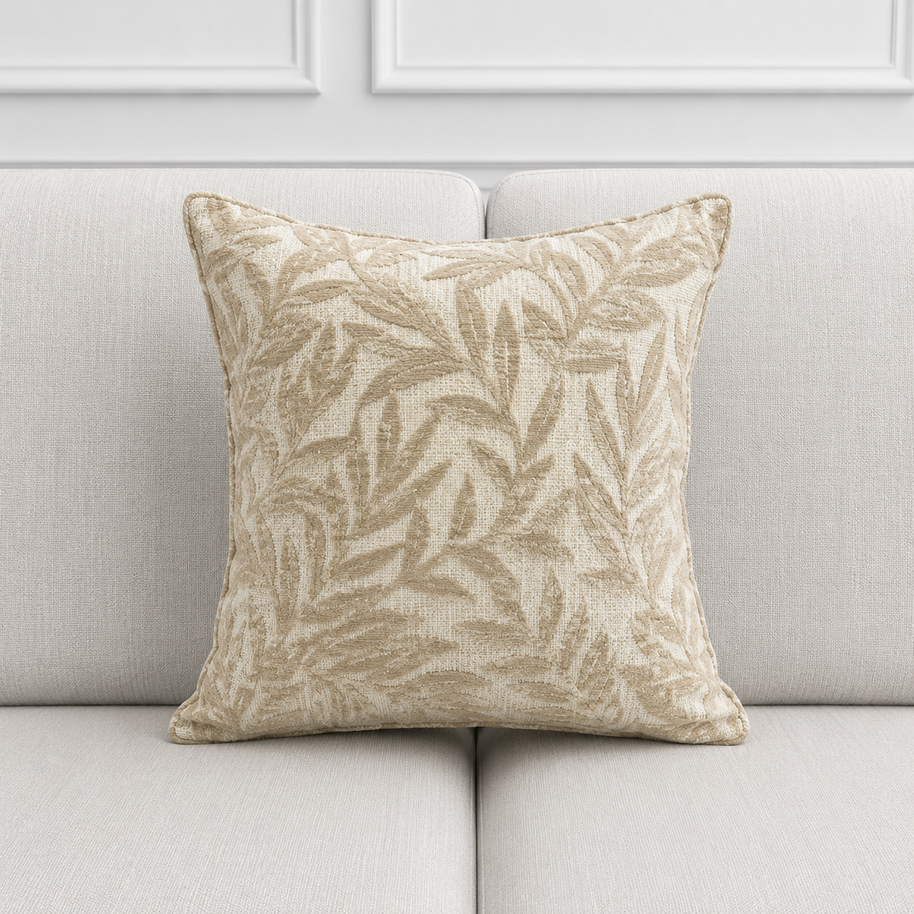 Decorative pillow with leaf pattern on a light gray sofa