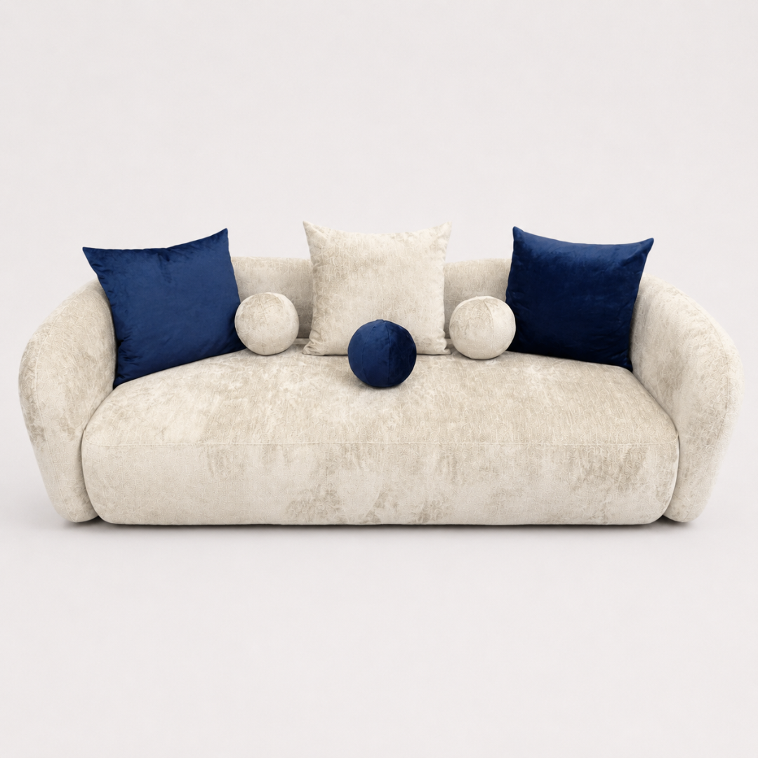 Beige sofa with blue and white cushions on a white background