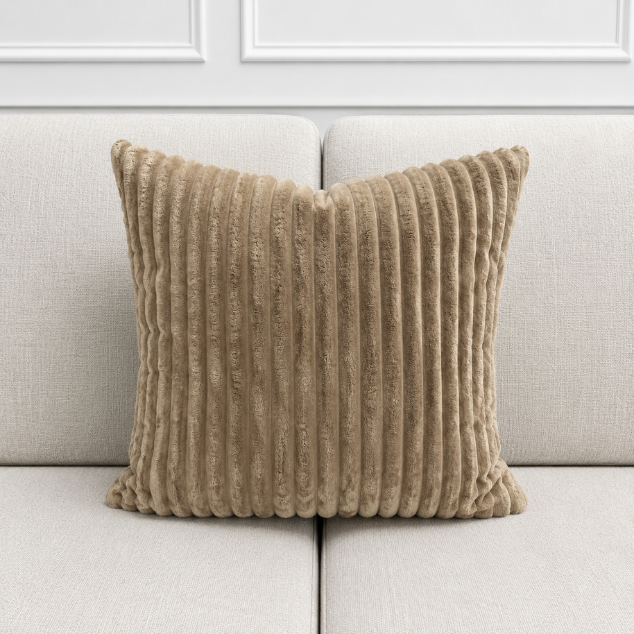 Mocha coloured textured pillow on a light gray sofa