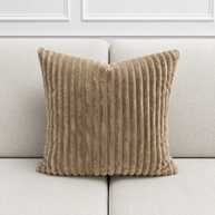 Mocha coloured textured pillow on a light gray sofa